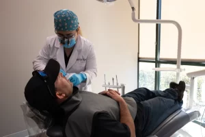 Dr. Daigle with a patient at Off the Trace Dental